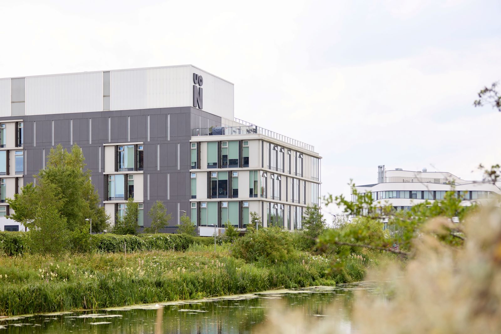View of Learning Hub building from across the river in Beckets Park.