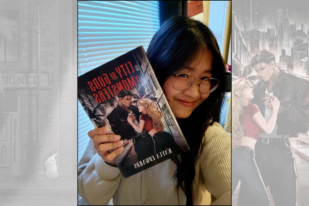 Student Annie smiles at the camera and holds her book next to her face as she smiles.