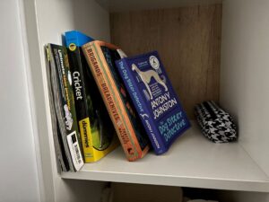 Selection of books and magazines next to a pencilcase on a shelf in Joe Kelly's study bedroom.