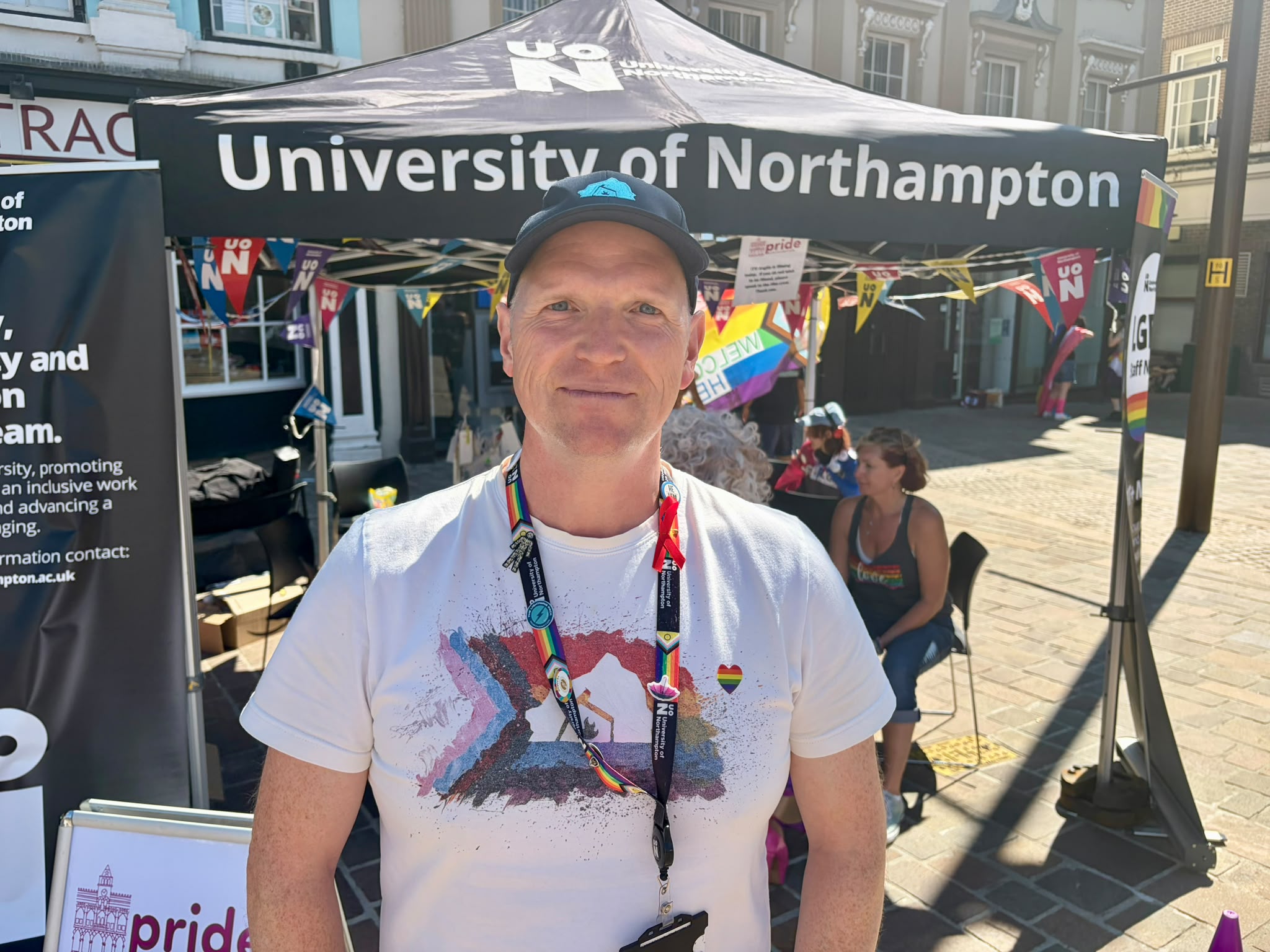 Nick smiles at the camera in front of a black 'University of Northampton' gazebo.