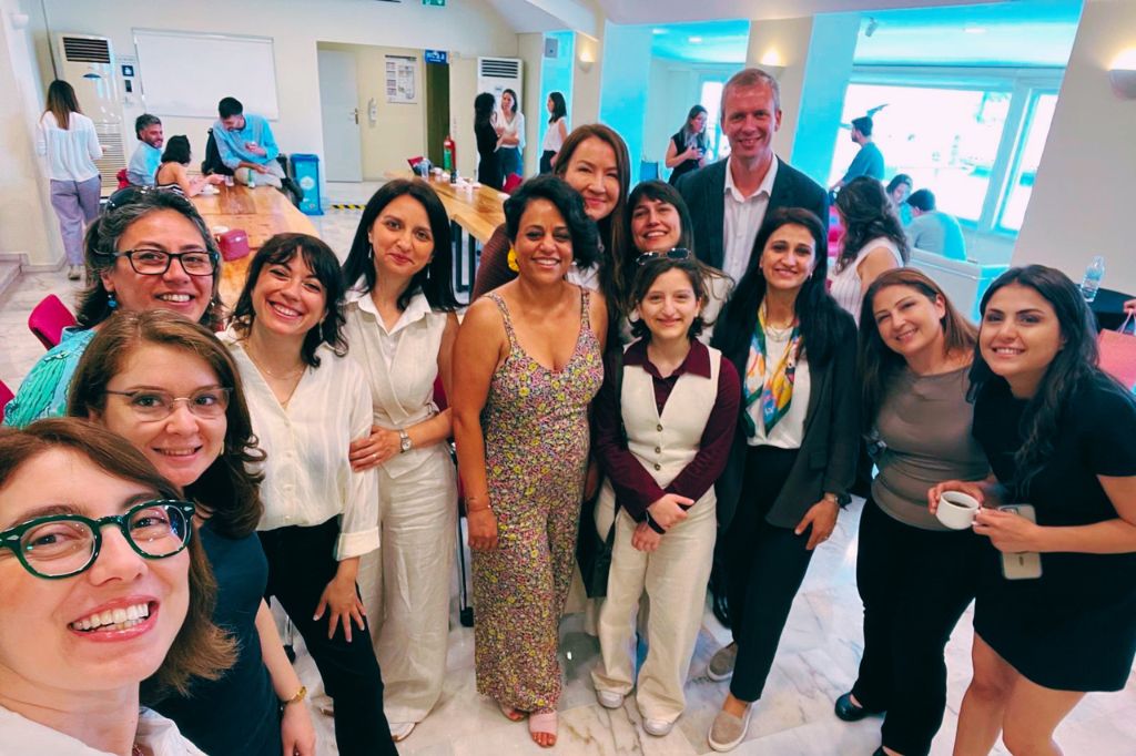 A dozen people in their party clothes celebrating the completion of a British Council Funded two-year project - Eco-Creative Pedagogies: Training the Next Generation of Teachers on Green Skills and Resilience