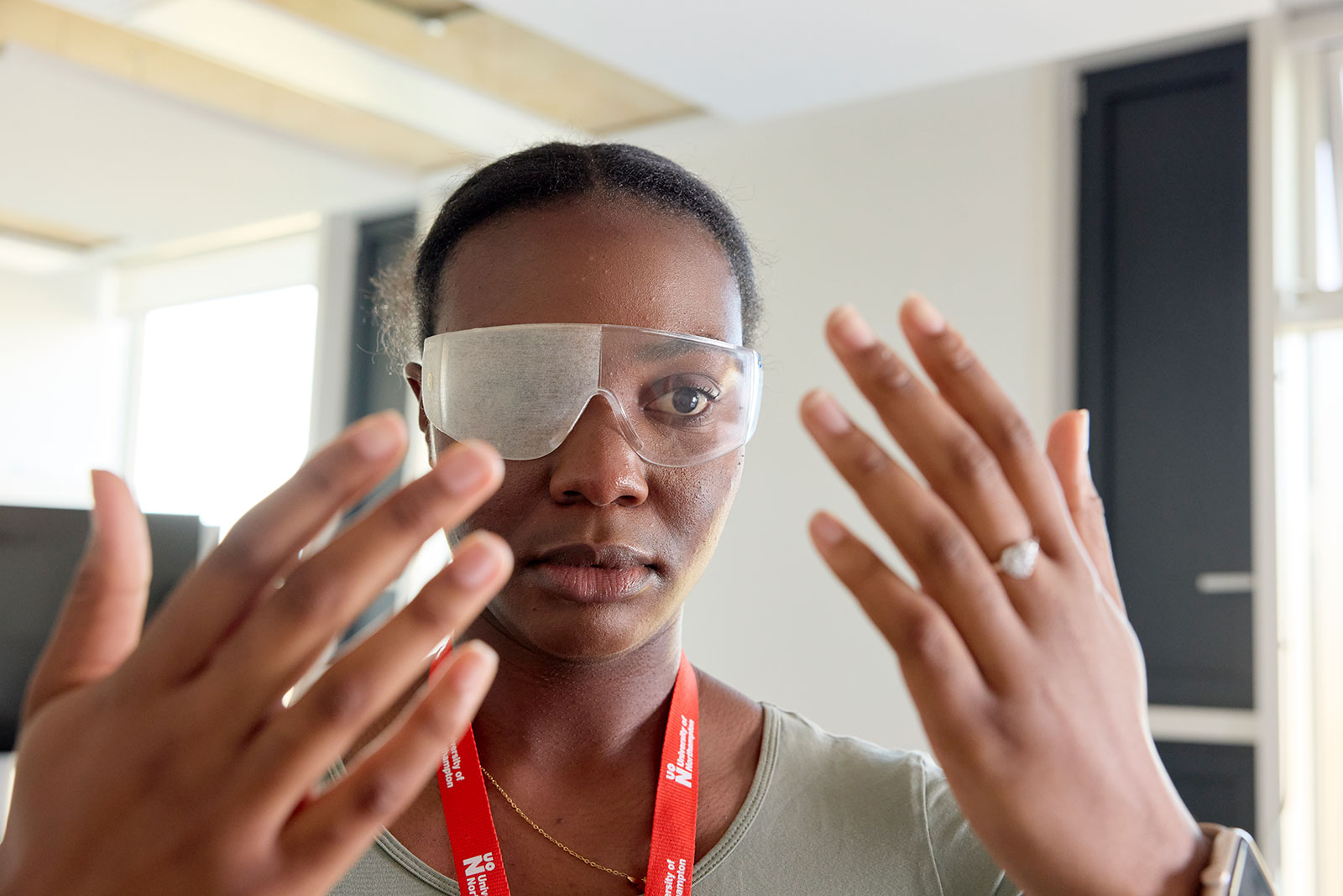Occupational Therapy student wearing simulation glasses designed to mimic visual impairments, gaining insight into how different health conditions can affect vision and everyday activities. The practical learning experience helps students develop empathy and understanding of the challenges faced by people with disabilities.