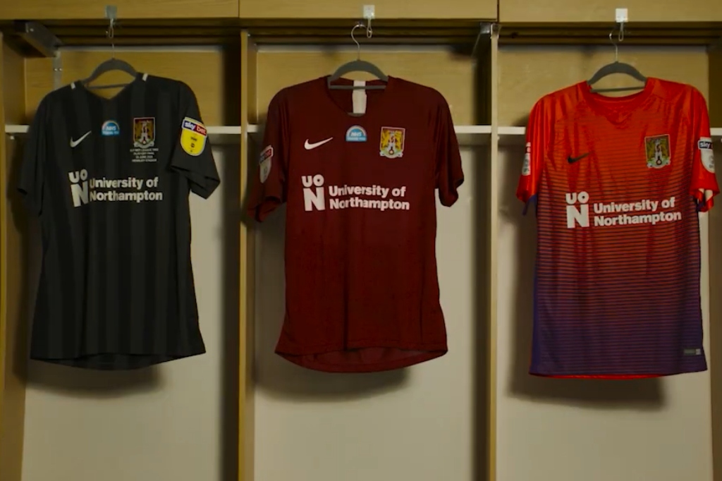 Three football shirts hanging with the UON logo on the front.