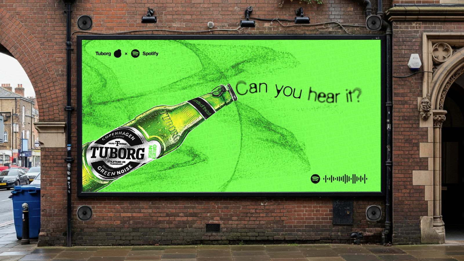 Student-designed billboard advertisement featuring a Tuborg beer bottle, bold typography and a bright green colour palette as part of a branded marketing campaign.