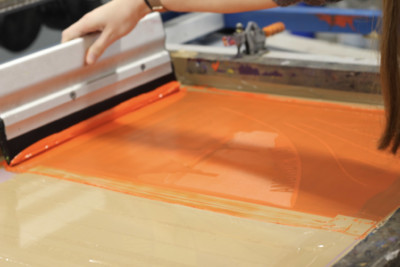 Screenprinting press with orange paint