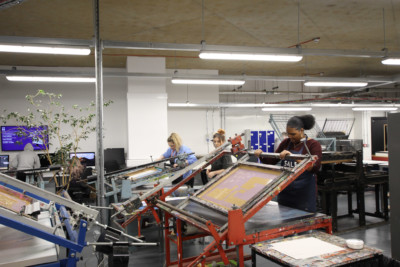 Students using equipment in printworking workshop