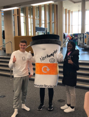 Two students with Cuppy mascot