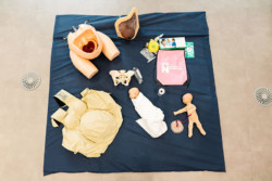 Equipment used in Midwifery course at UON, including manikins, pregnancy suit, and other equipment.