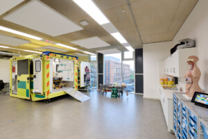 Angle of the clinical suite showing a skeleton mannequin and part of the ambulance simulator, which shows the inside of an ambulance.