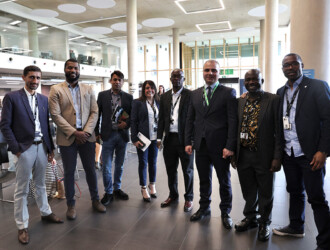 Photo of 6 UON Staff Members standing together, looking at the camera and smiling. They are standing at the UON Sustainability Summit 2023.