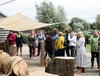 Nadia Norman presents to a crowd of people outside at Stanwick Lakes