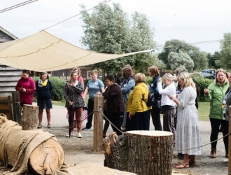 Nadia Norman presents to a crowd of people outside at Stanwick Lakes