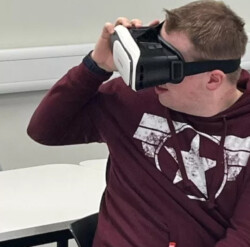 A person looks through a virtual reality headset