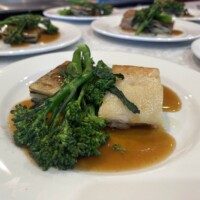 Pressed pork belly with black pudding, potato terrine, tender stem broccoli & pork scratching