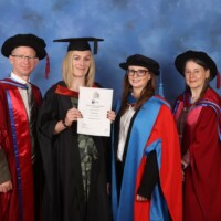 One of the graduate award winners, UON Senior Student Communications Officer Emily, is pictured holding her certificate alongside her subject area academics.