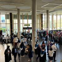 A crowd of soon-to-be graduates are pictured gathering in the Learning Hub to be ‘gowned up’ for their Ceremony.