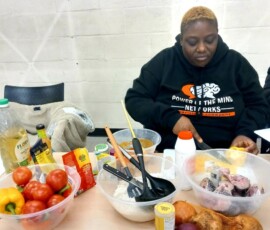 Image of a person chipping vegetables and putting them into a mixing bowl.