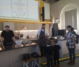 Image of 2 children and two chefs at the Community Kitchen