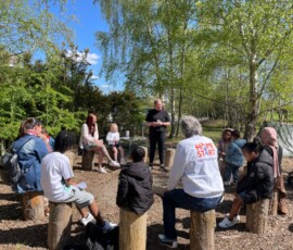 Image of people gathered in a circle taking a workshop on nutrition and food.