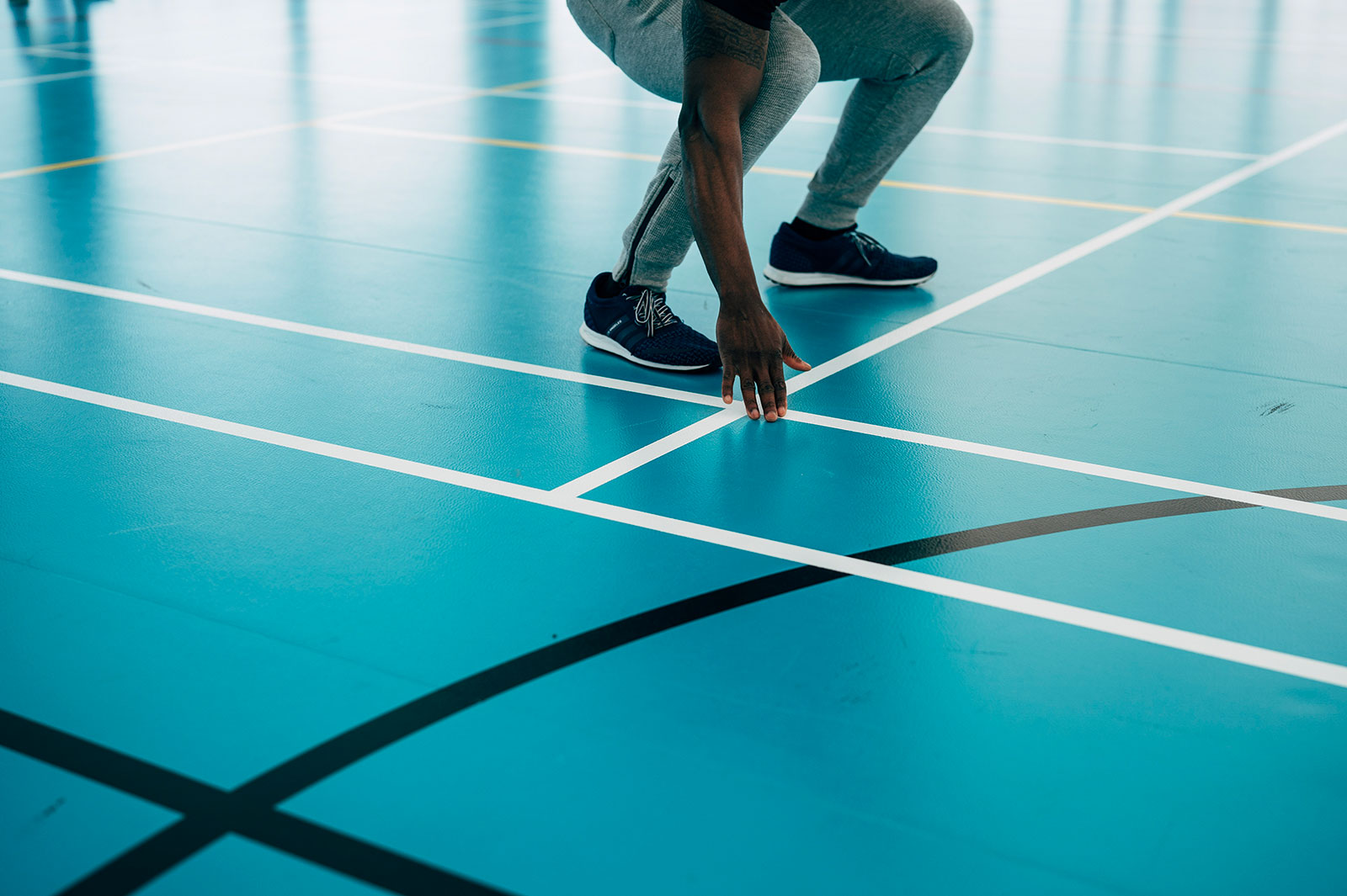 Person next to lines in indoor sports pitch