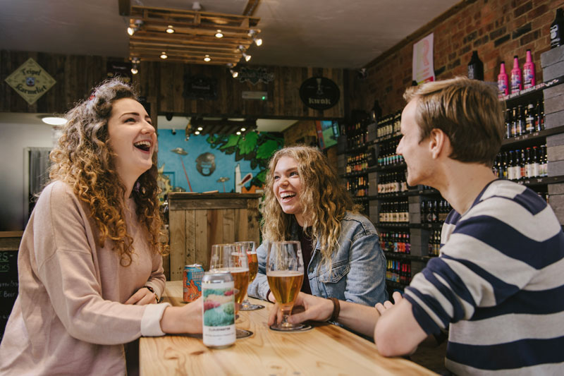 Three students in bar in Northampton.