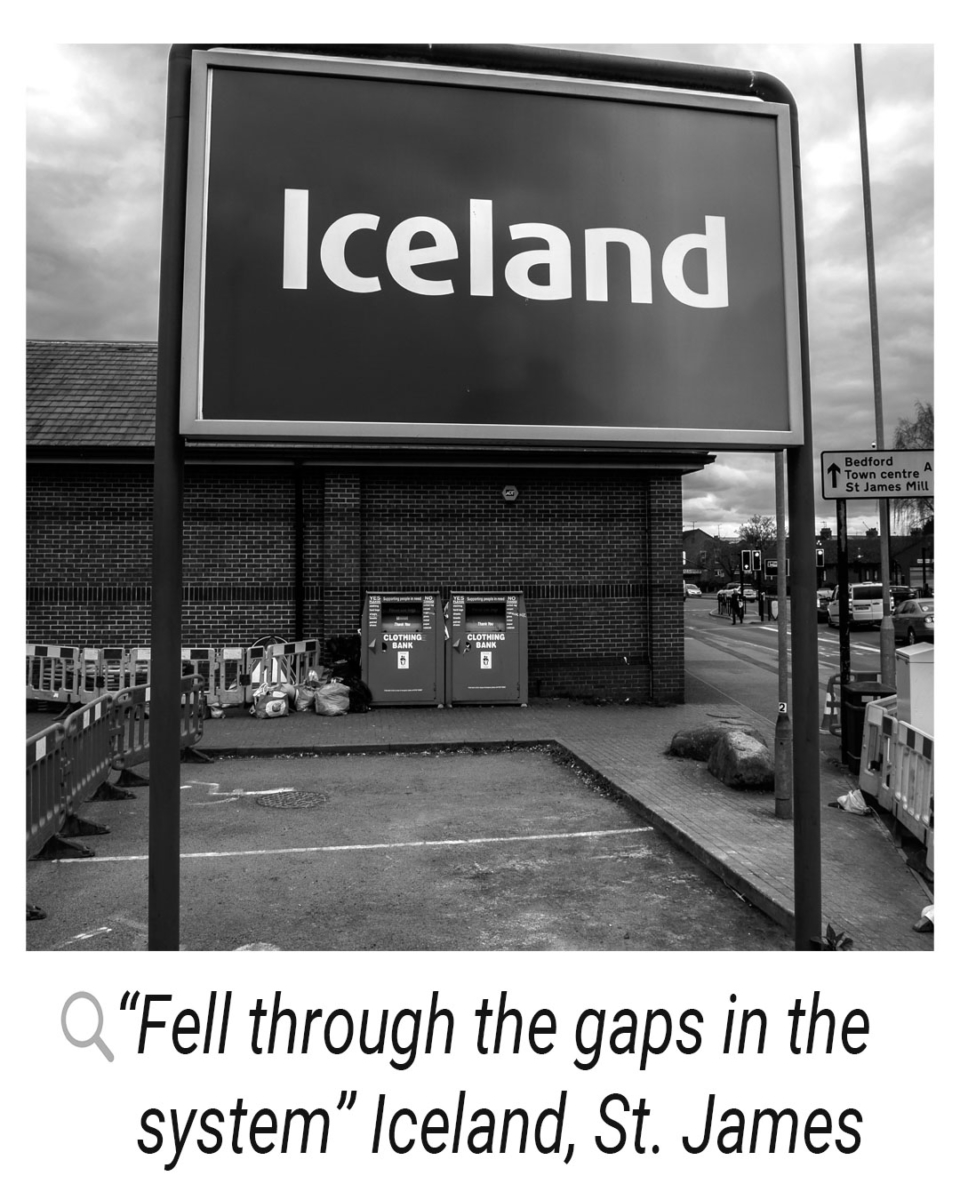 Iceland grocery shop with the “Iceland” logo sign with a quote alongside it “fell through the gaps in the system”, Iceland, St. James