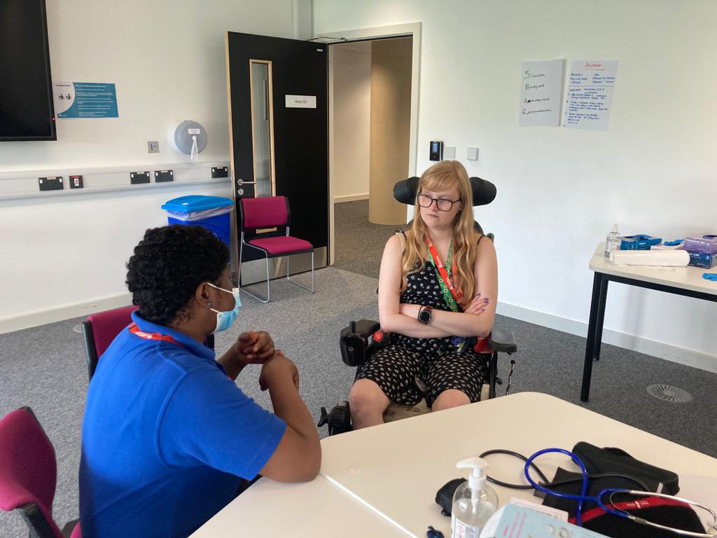 Two students from the service user group talking to each other