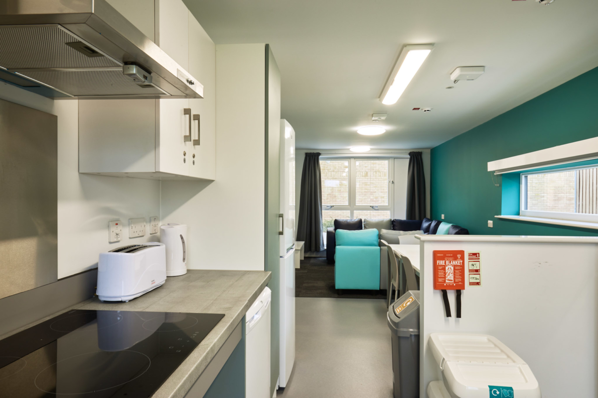 Kitchen and communal living area in accessible flat on Waterside campus